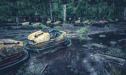 Broken metal radioactive cars in amusement park in Pripyat, the Chernobyl disaster