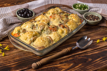 baked cauliflower with cheese and mushrooms in the kitchen at home.