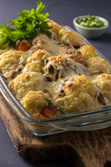 baked cauliflower with cheese and mushrooms in the kitchen at home.