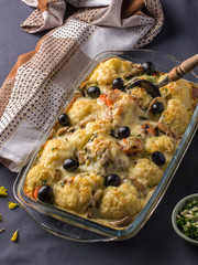 baked cauliflower with cheese and mushrooms in the kitchen at home.