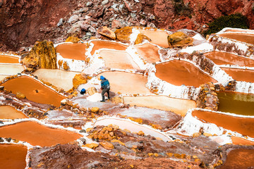 Worker at Salinas de Maras near Cusco, salt extraction in Peru