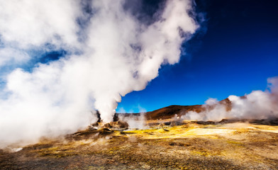 Fototapeta na wymiar Sunshine Boivian desert landscape with huge steaming geysers