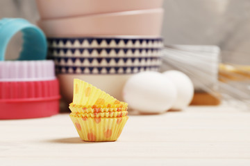   Baking utensils and ingredients. rolling pin, cupcake cases on a white wooden background. Easter concept.