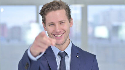 Portrait of Young Businessman Pointing Finger at Camera