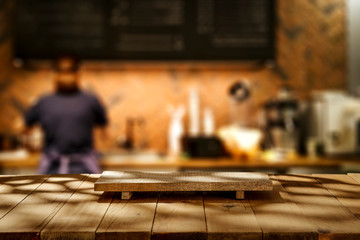 Desk of free space for your decoration and blurred background of cafe 