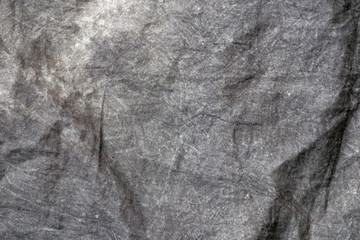Crumpled fabric texture, dark gray cloth background. Copy space