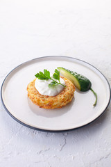 potato pancakes with sour cream , fresh cucumber and herbs