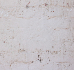 old plaster, light wall with white paint with beige and coral color.