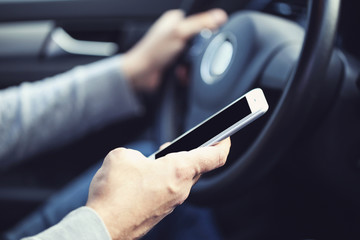 Man using mobile phone while driving car