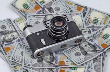 Vintage film camera on scattered American dollars.