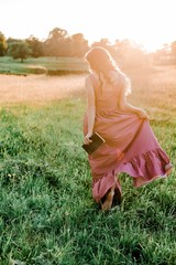 Obraz premium Dreamy girl walk in the Summer at Sunset