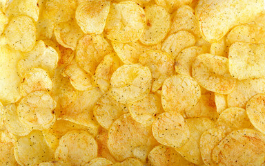 appetizing yellow potato chips background - 329860316