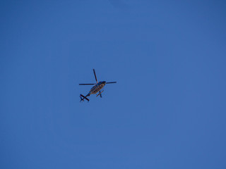 police helicopter in the blue sky