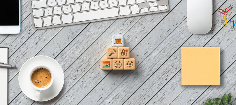 cubes with marketing symbols on wooden background