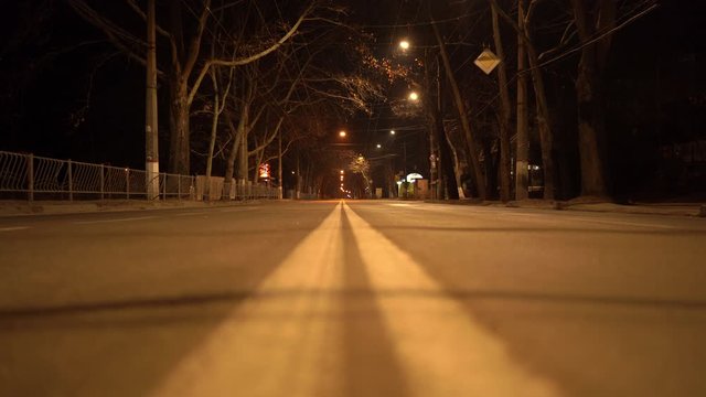 Simferopol empty city streets with street lights at night in autumn. Dividing line on the road.