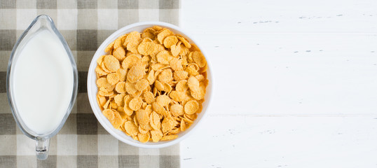 Corn flakes, milk on the tablecloth. Healthy and nutritious Breakfast. White background. Copy space