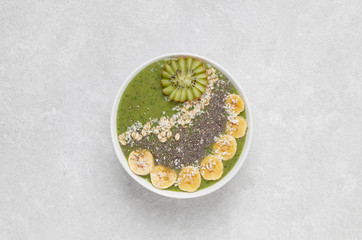 Healthy Breakfast smoothie bowl with avocado, spinach, kiwi, spinach and Chia seeds.