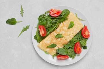 Omelette with spinach, arugula and cherry tomatoes. Healthy delicious Breakfast