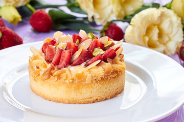 Strawberry mini tart on purple wooden background
