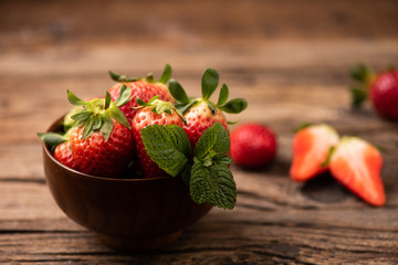 Fresh strawberry in basket on wooden rustic table