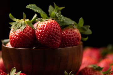Fresh strawberry in basket on wooden rustic table
