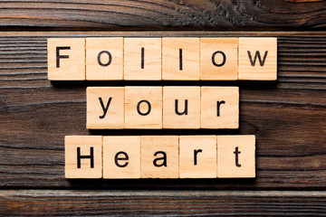 Follow your heart word written on wood block. Follow your heart text on wooden table for your desing, Top view concept