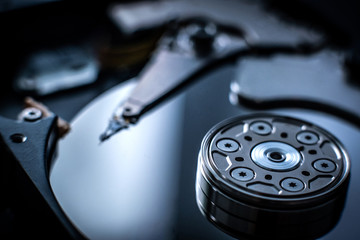 Closeup macro photo of head cylinder in hard disk drive on dark blurred background