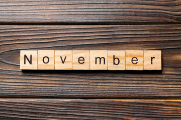 November word written on wood block. November text on wooden table for your desing, Top view concept