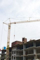 Industrial background made of crane construction at the buildings background at the building area