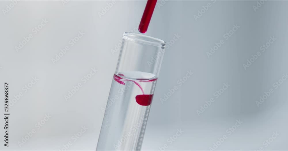 Wall mural scientist with pipette analyzes red colored liquid to extract the dna and molecules in the test tube