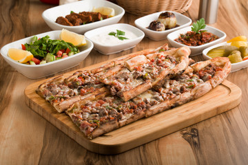turkish meat pide on wooden table