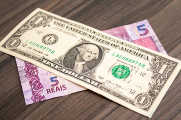 US dollar bill and Brazilian reais banknotes, business finance exchange market