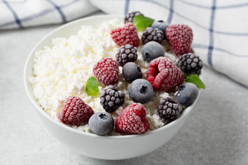 Cottage cheese with berry blueberry, raspberry and blackberry, selective focus