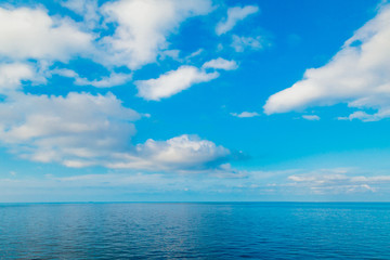 blue sea horizon and sky with clouds