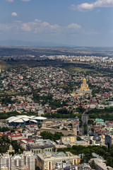 Cityscape of Tbilisi, Georgia as viewed from Mtatsminda View Point. The Holy Trinity Cathedral of Tbilisi is a prominent landmark.