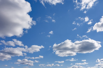 Blue summer sky with white cumulus clouds. Blue sky with clouds nature background.