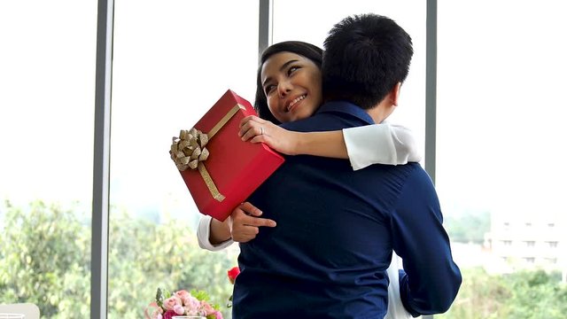 young beautiful attractive asian woman received gift from her boyfriend husband for marriage in the restaurant at dinner time with love new normal