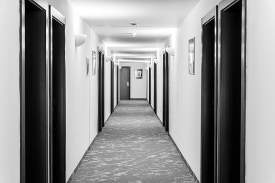 White corridor with black doors in the hotel