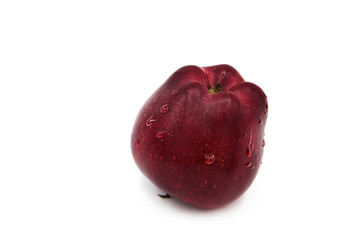 Ripe red organic apple with drops of water isolated on a white background.