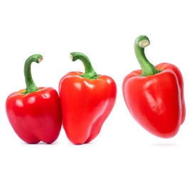 Three fresh red peppers closeup on a white background