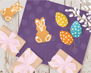 Easter banner with gift box, Easter Eggs, cookies, willow, napkin on a wooden table, holiday