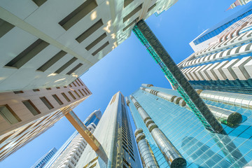 Looking up to high-rise office buildings, skyscrapers, architectures in financial district with...