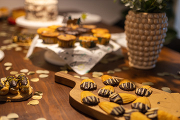 petite Madeleines decorated like bear paws with chocolate and almonds on a table.