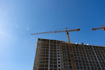 Home construction, construction cranes, unfinished house