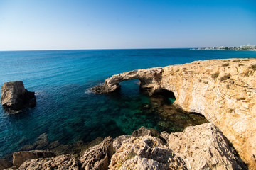 Beautiful sunset at natural stone bridge near Ayia Napa on Cyprus, Europe. Love bridge. Cavo greco.
