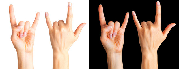 Set of women's hands showing rock n roll sign or giving the devil horns gesture