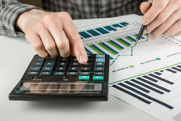 A man is analyzing a financial report.