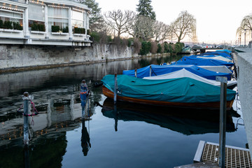Bunch of covered docked small boats on the river Limmat in Zurich Switzerland