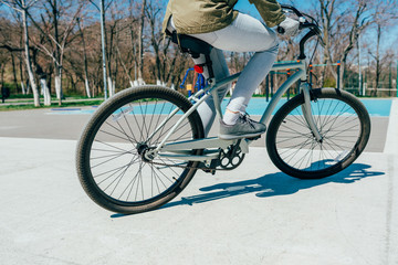 Fototapeta premium Close-up of woman's legs pedaling bicycle