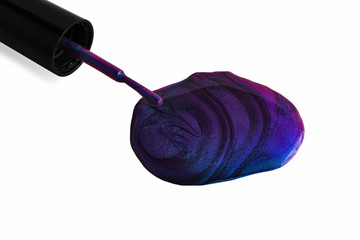 Smear of multichrome nail polish with brush near it.Isolated on white.Beautiful stains of liquid...